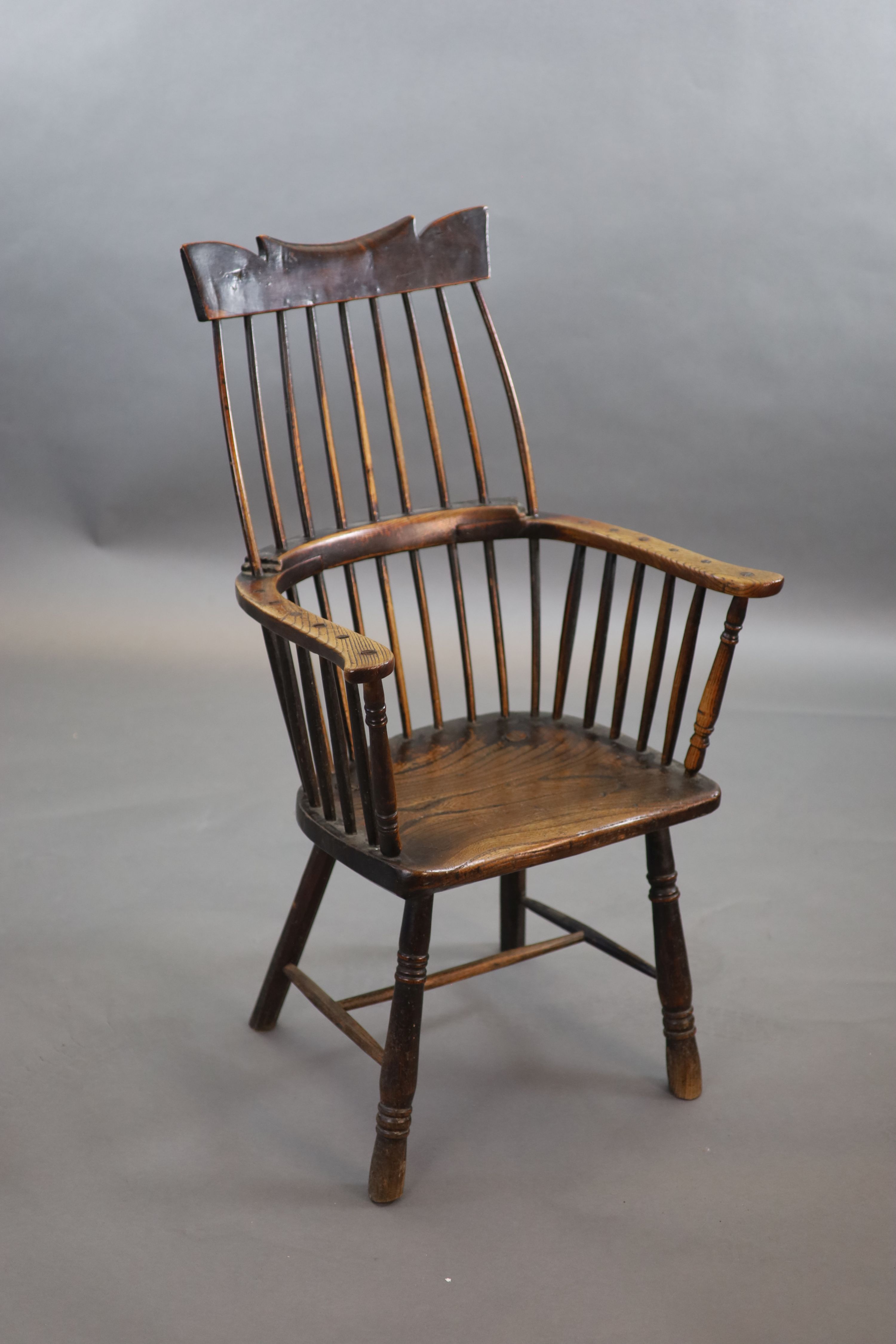 A primitive comb back Windsor armchair, possibly West Country, 67cm wide, 39cm deep, 106cm high.